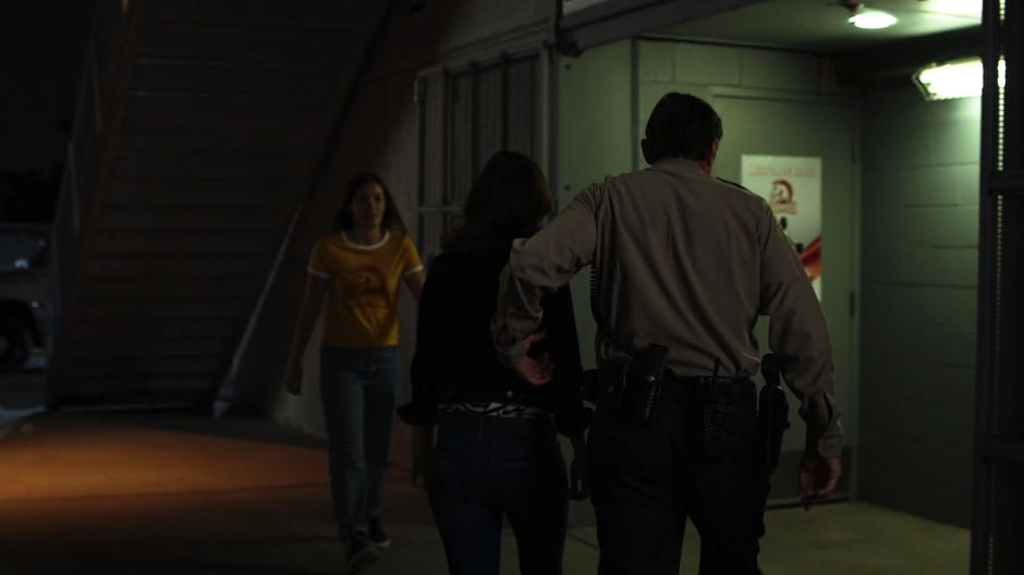 Sheriff Collins leads Alex into the area under the stadium.