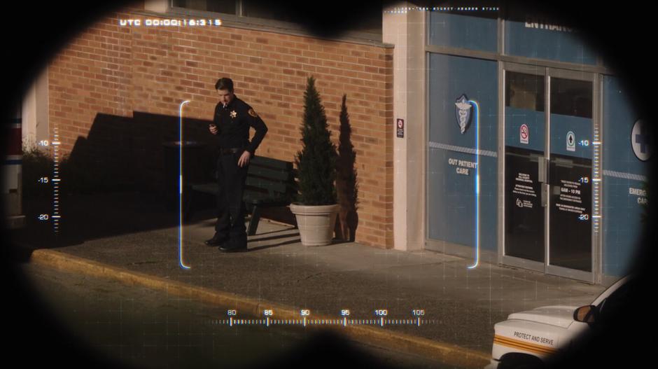 Officer Rizzio stands in front of the hospital smoking.