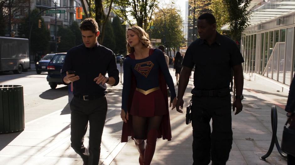 Kara and J'onn look at Winn's screen as he leads them to the buried ship's location.