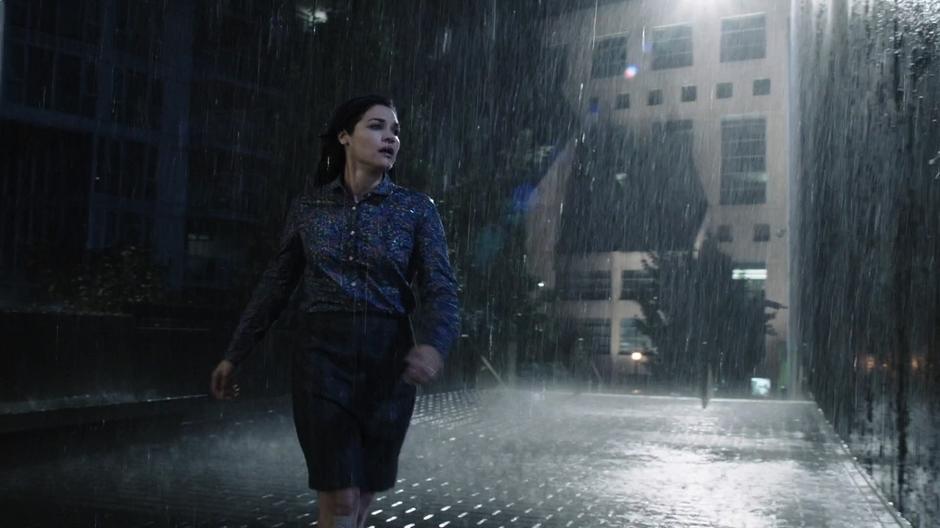 Marlize runs through the rain looking for her husband after the explosion.