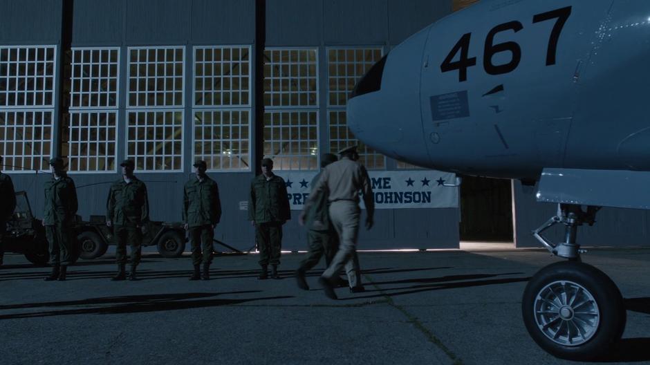 President Johnson follows a soldier into the hanger.