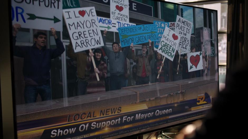 Protesters in suport of Oliver assemble in front of the station on the news footage.