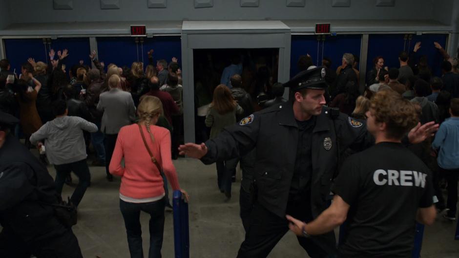 The fake police try to stop people from leaving the stadium.