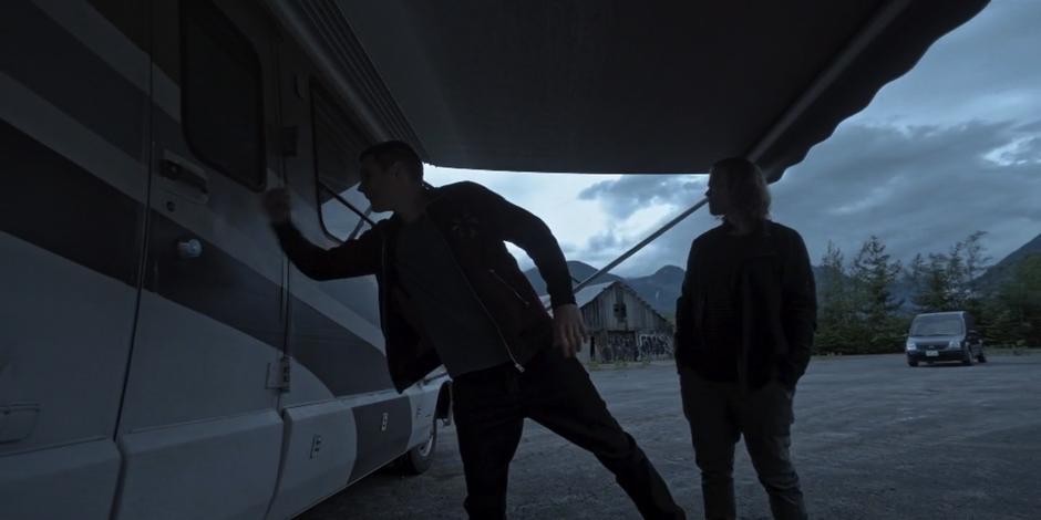 Trevor knocks on the door to the RV with Philip.