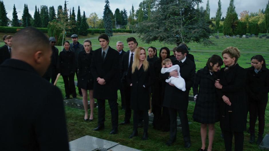 Jax walks over to where Lily and Clarissa are standing with the rest of the mourners.