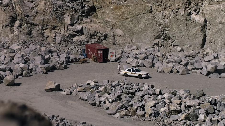 The Mage works around a police car down in the quarry.