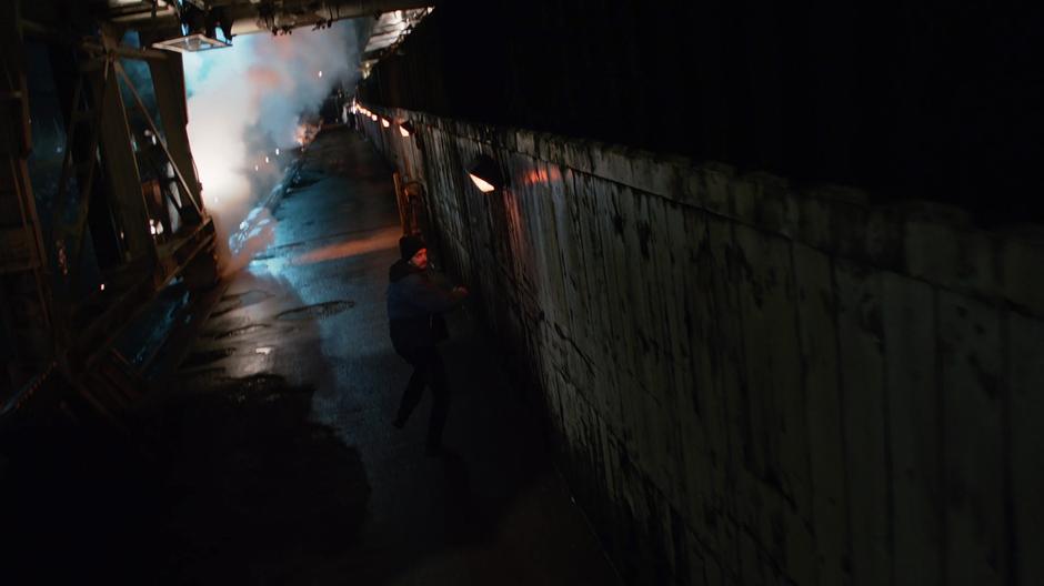 One of the gang members looks behind him as he is chased by Reign.