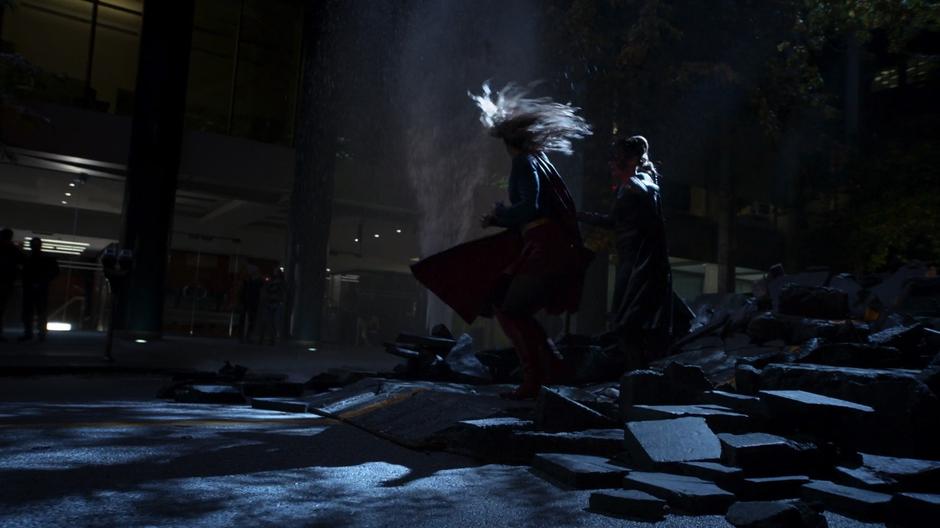 Kara and Reign fight in the street while people watch them.