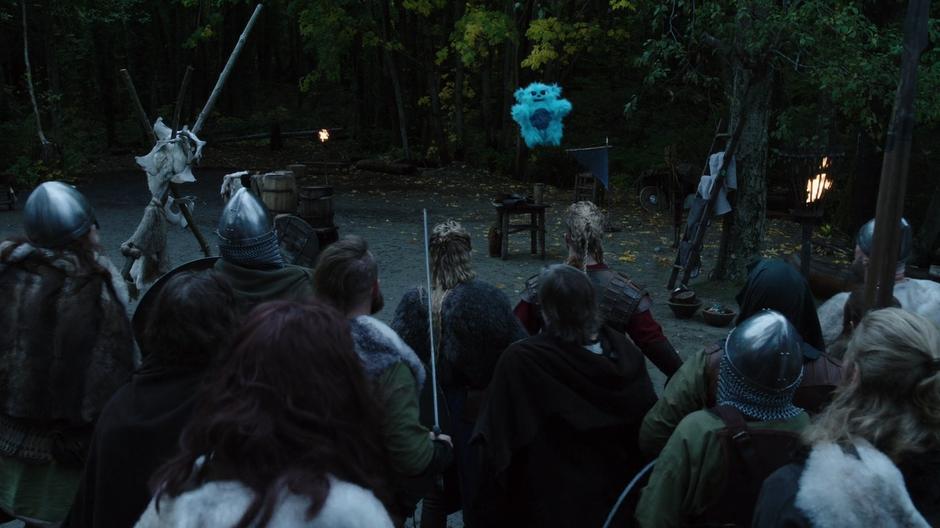 Beebo hovers in front of the angry Vikings telling them to stop fighting.