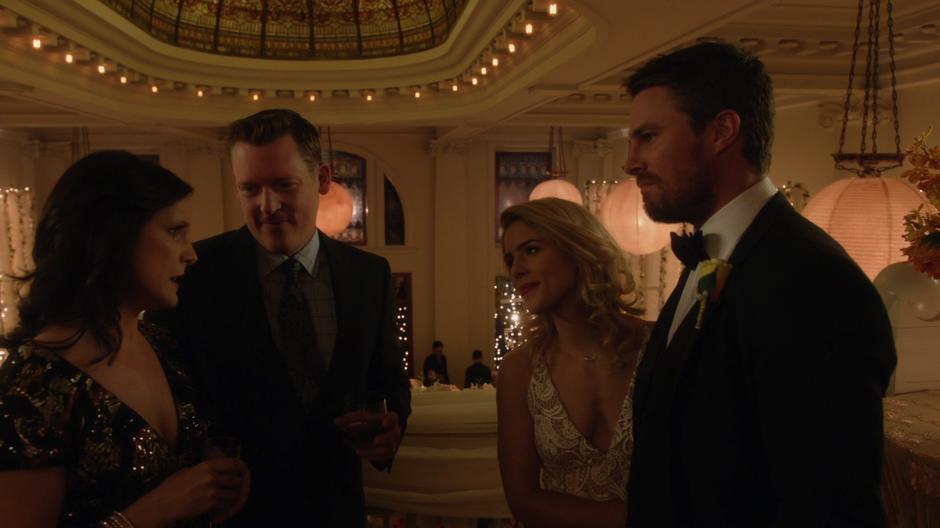 Felicity and Oliver talk to their old friends from Ivy Town on the balcony.