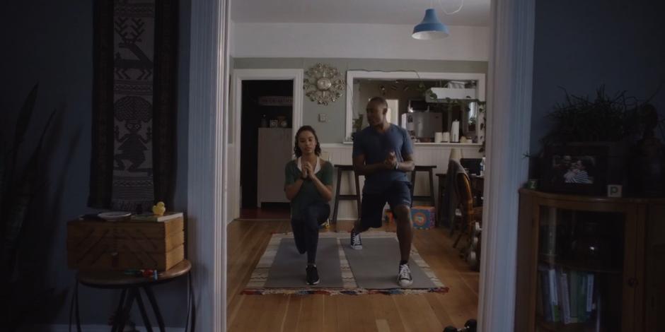 Carly and Jeffrey exercise in their dining room.