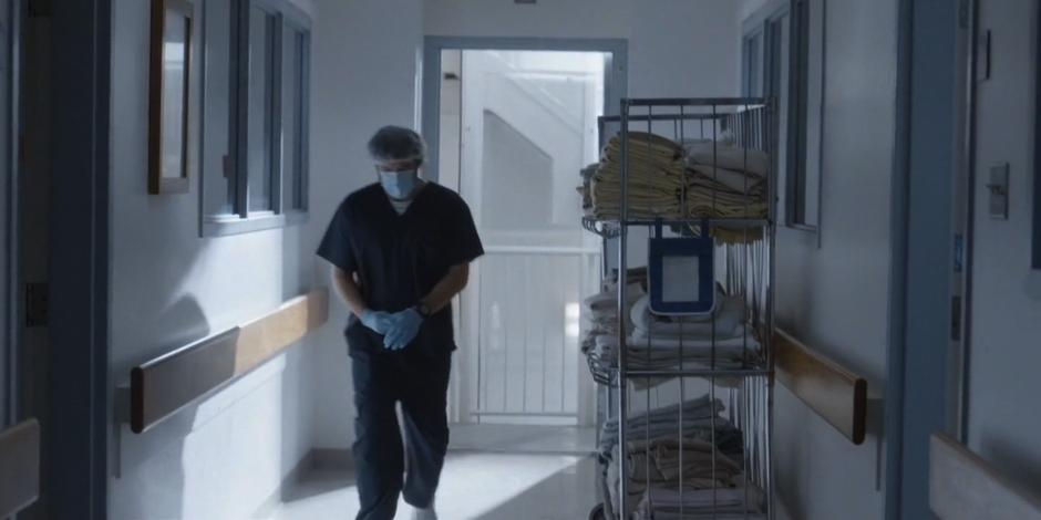 Rick walks down the hallway from the stairs to Kat's room.