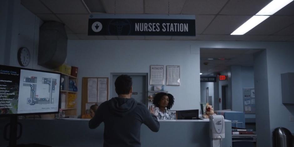Grant approaches the nurse looking for an update.