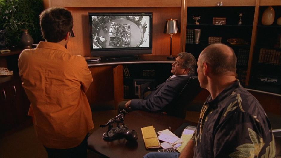 Bill Peterson and Henry show Shawn the surveillance video of Brandon's theft from the office safe.