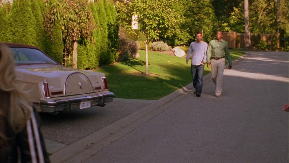 Shawn and Gus walk down the street to Lassiter's house.