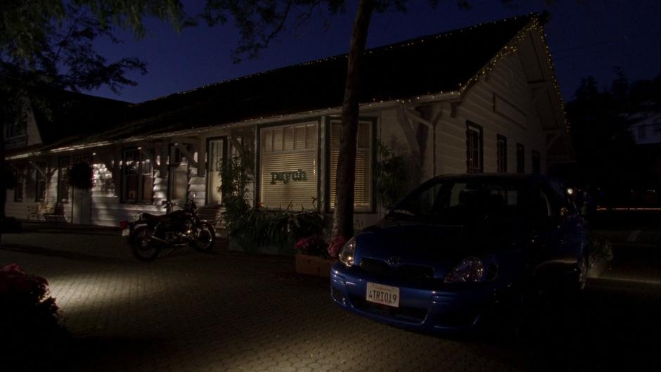 Nighttime establishing shot of the office with the Blueberry parked out front.