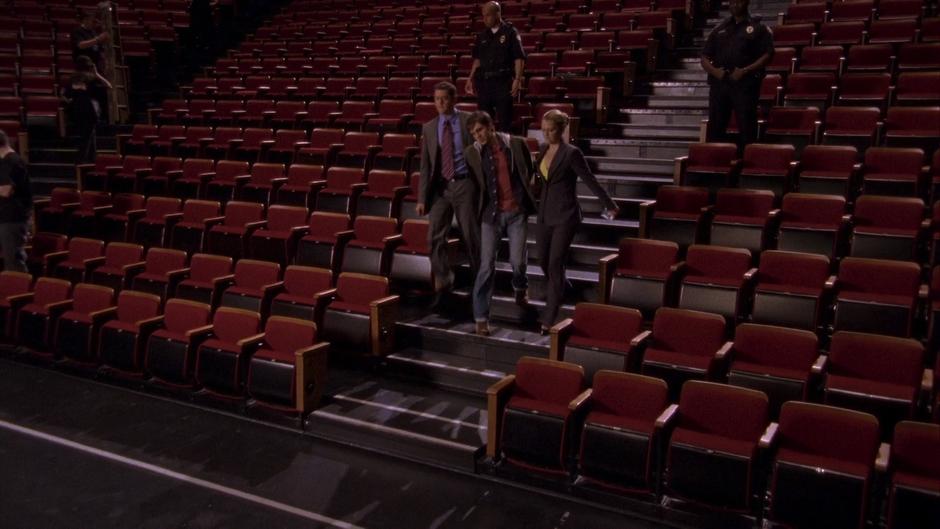 Lassiter and Juliet lead Bevin Rennie Llywellen down the stairs in the theater.