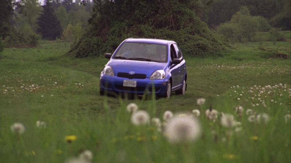 Gus drives the Blueberry across a field with Shawn.