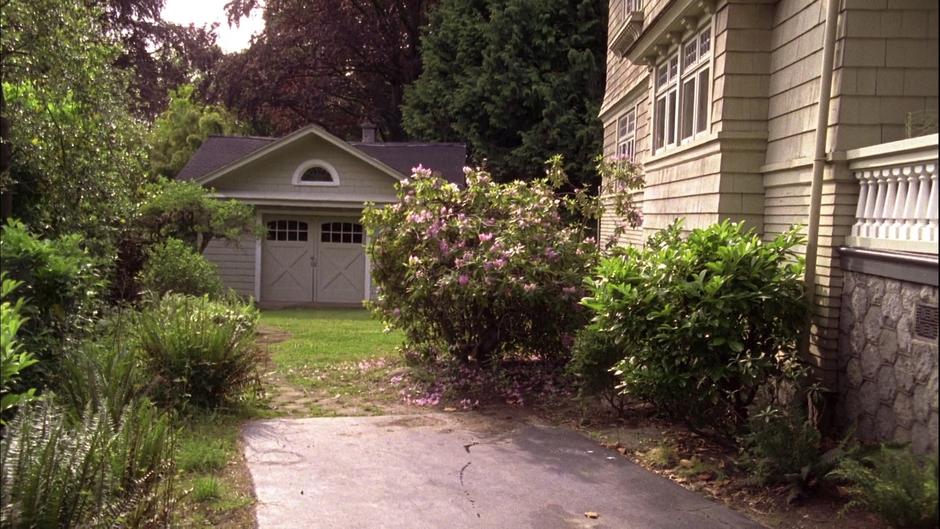 A shed sits behind the house.