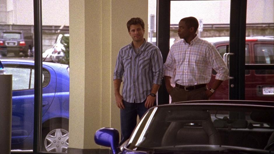 Shawn and Gus walk into the dealership.