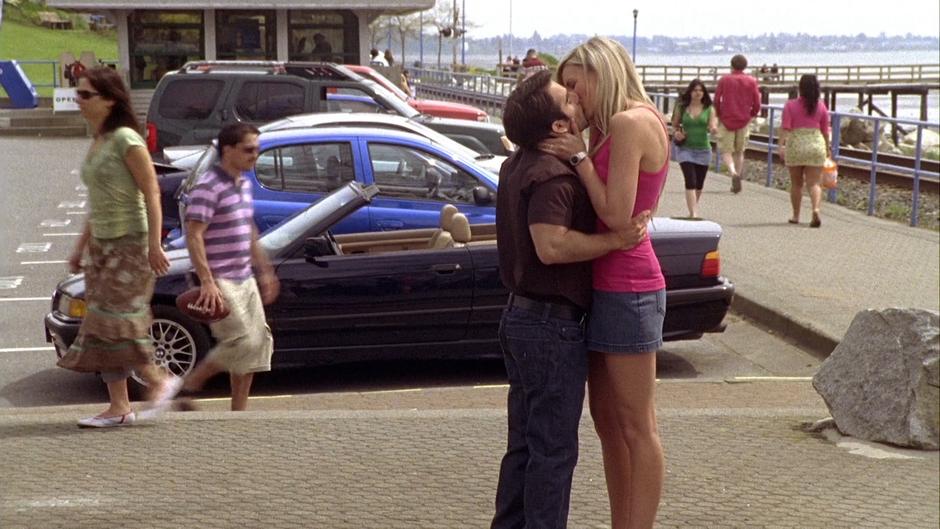 Jimmy Nicholas kisses his wife beside the parking lot.