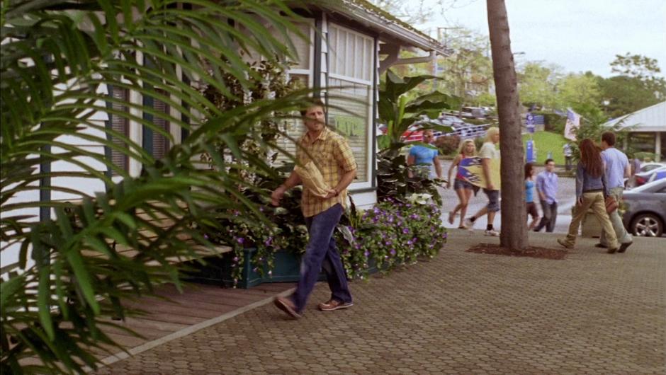 Shawn walks back to the office with snacks.