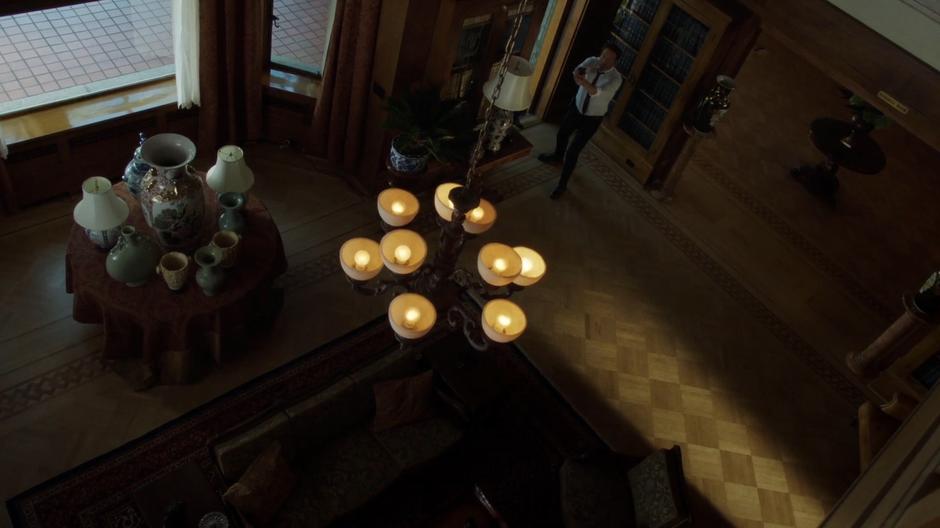 Mulder points his gun around after entering the mansion through the back door.