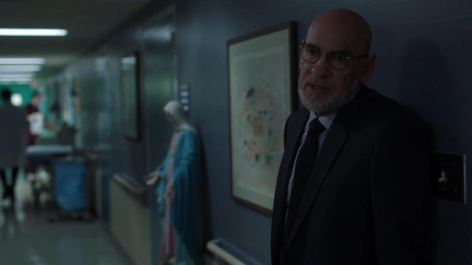 Skinner talks to Mulder and Dr. Joyet in the hallway.