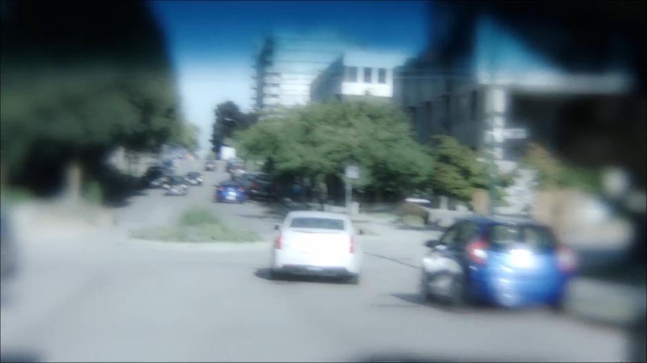 Scully's vision goes all woozy as she drives towards the intersection.