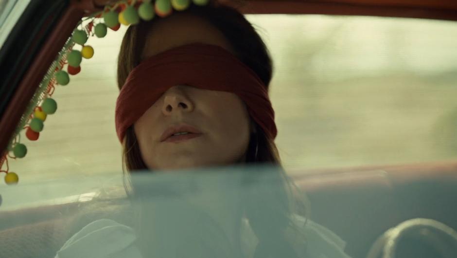 Mary listens to the sounds outside while blindfolded.
