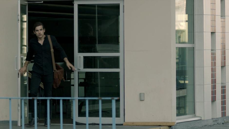 Quentin exits the door on the roof of the post office.