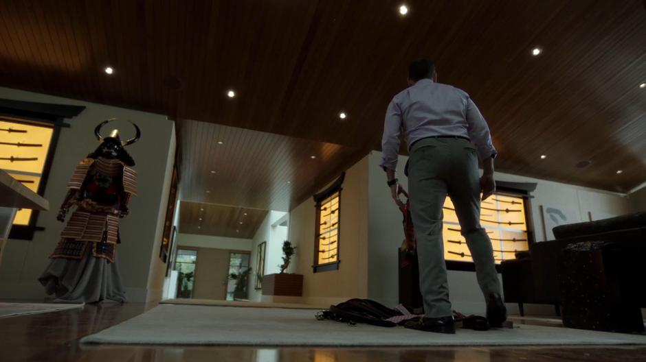 Dean Cavalier drops the pile of belts and ties and looks at his sword collection in the main hall.