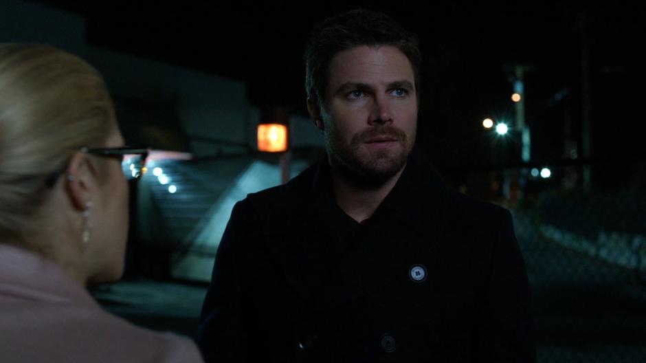Oliver listens to Felicity's information on the bug.