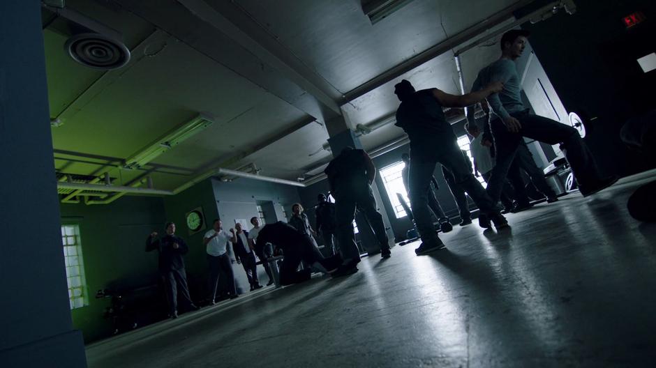 Barry fights with several inmates in the gym.