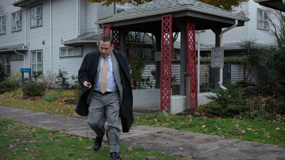 Councilman Grovner pulls out his car keys as he walks out of his house.