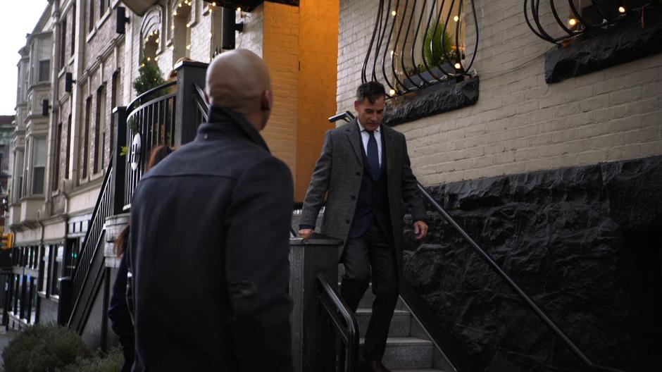 Edge walks out of the restaurant down the stairs to where Lena and James are standing.