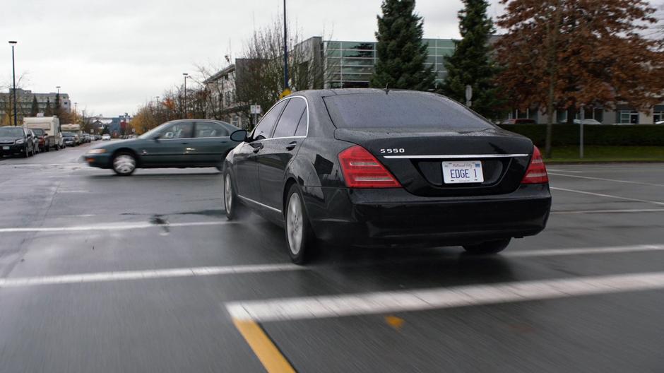 Edge's car narowly misses a car while driving out of control through the intersection.