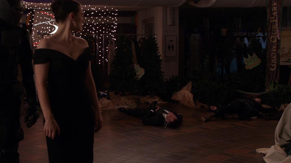 Lena looks behind her to where Edge and Lillian are knocked out on the ground.