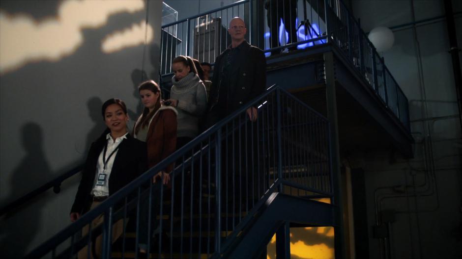 Sylbert Rundin walks down the stairs in the middle of a tour group.