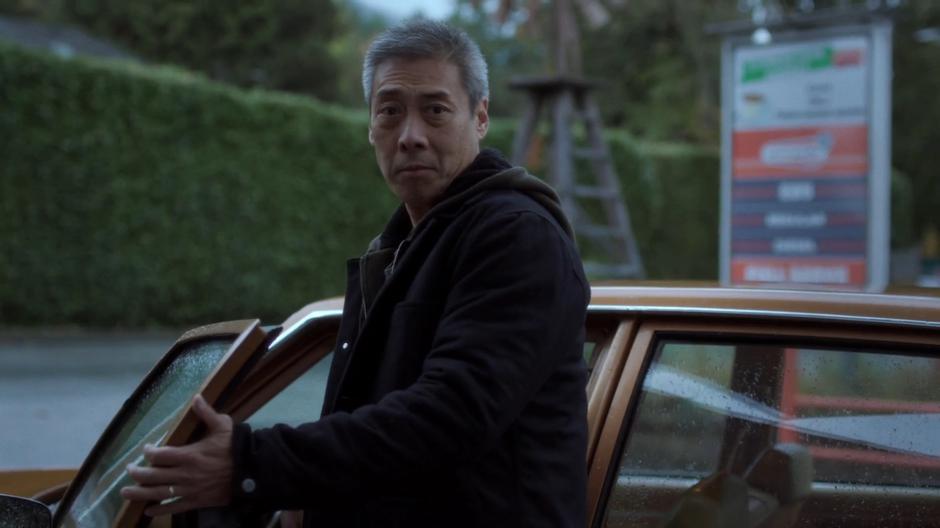 Peter Wong turns back to say one last thing to Scully before driving off.