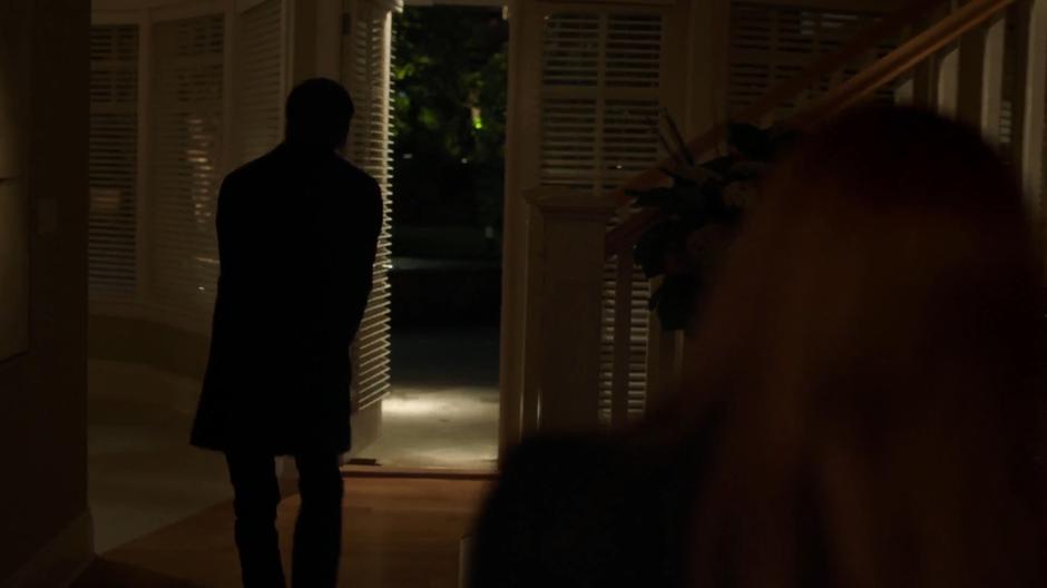 Mulder and Scully search through the house.