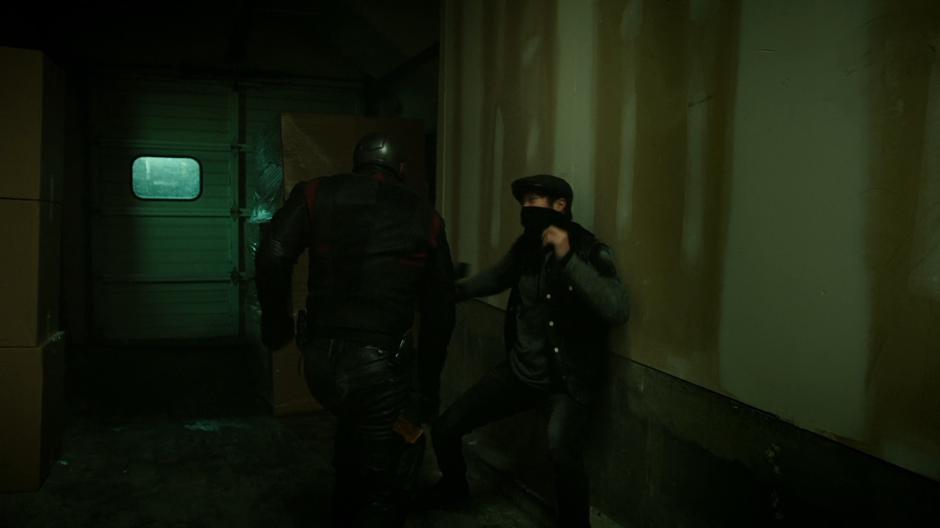 Diggle fights one of the goons.