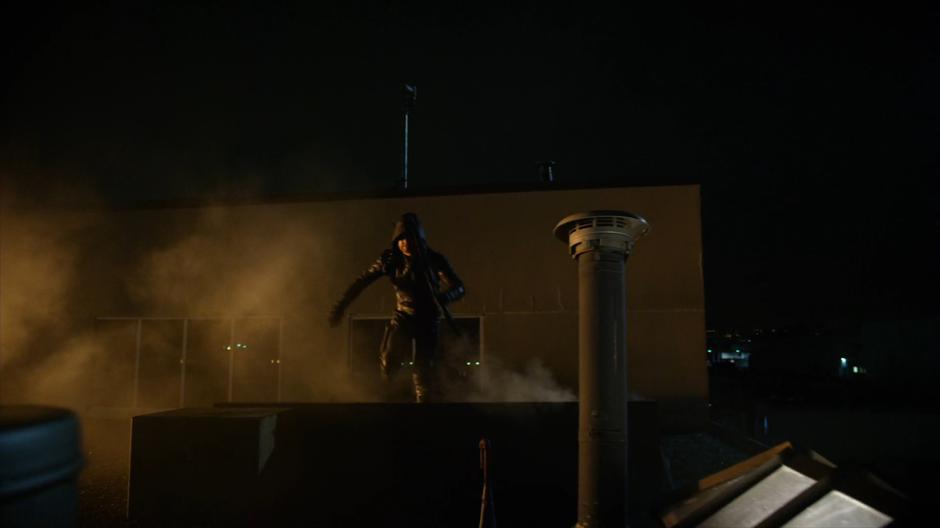 Oliver runs along the roof of the building.