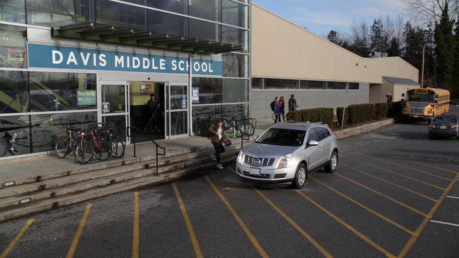 Ruby runs out to the car as Sam pulls up out front of the school.