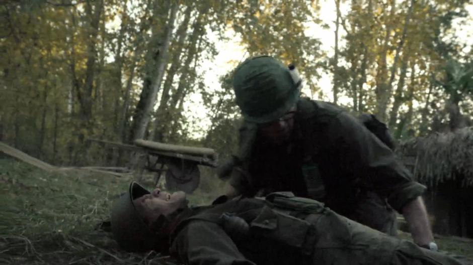 Skinner crouches over Quon who was shot by enemy fire.