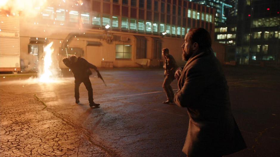 One of the guards his hit by an arrow while another jumps back from an explosion and Anatoly pulls out his gun.