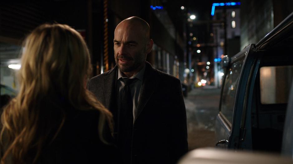 Lance talks to Black Siren in the alley before heading inside.