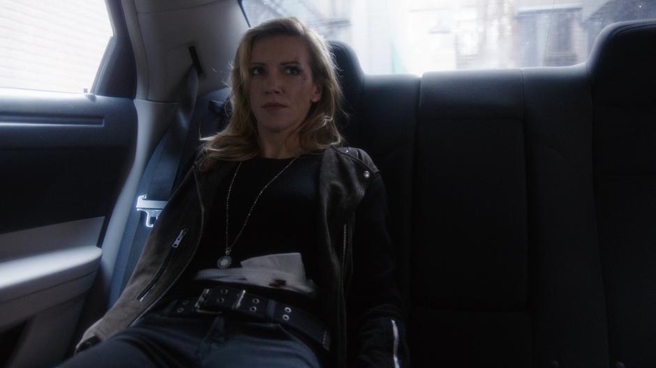 Black Siren listens to Lance from the back seat.