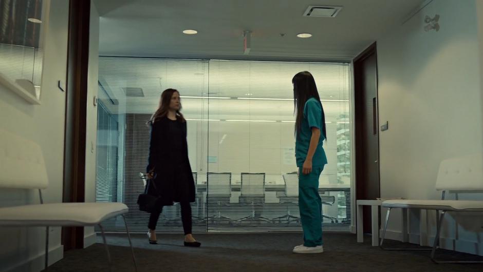 Annie stands up as Mary walks out of the meeting.