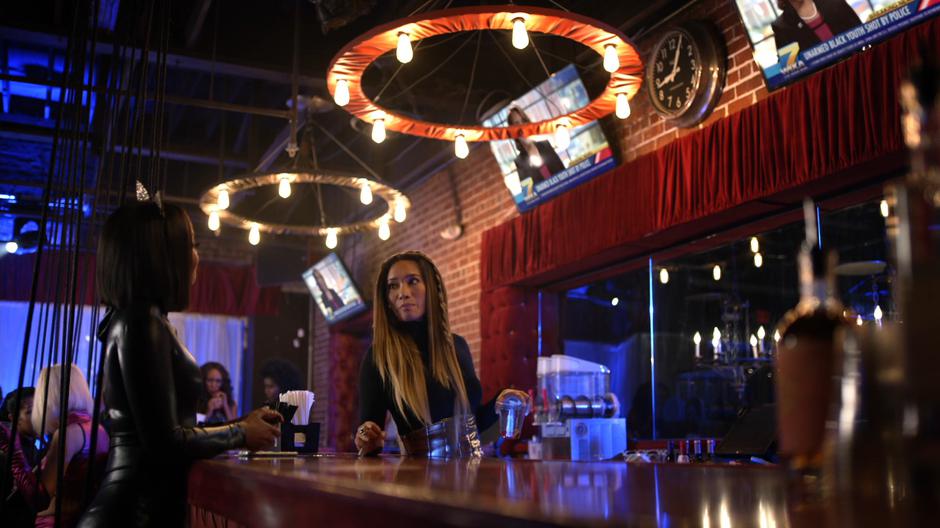 Grace listens to Anissa's woes while working behind the bar.